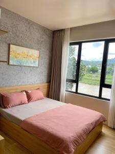 a bedroom with a bed with a large window at Tít Mít HomeStay in Cao Bằng +89 photos