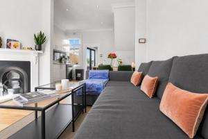 a living room with a gray couch and a table at 2 Bedroom House Woolloomooloo in Sydney