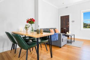 a living room with a table and a couch at 2 Bedroom House Woolloomooloo in Sydney +12 photos