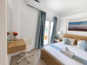 a bedroom with a bed and a desk and a window at Anris & Dianas Dom - In a quiet part of the center in Kallithea Halkidikis