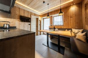 a kitchen with a large wooden island in a room at Col Dala Vara in San Cassiano