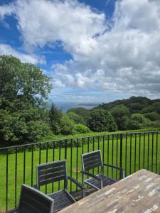 two chairs and a table on a balcony with a view at 43 sea valley in Bideford