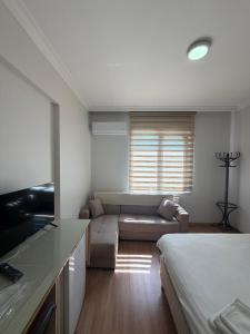 a living room with a bed and a couch at Korkmaz Rezidans in Kayseri