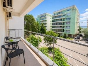 a balcony with a table and a view of a street at MAMAIA SAMMERLAND APARTAMENT 3 camere in Mamaia