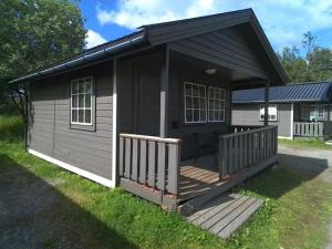 a small house with a porch and a deck at Saltstraumen camping in Bodø