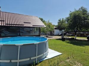 a swimming pool in the yard of a house at Pensiunea Beatrice in Sovata