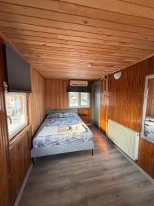 a bedroom with a bed in a wooden room at Erkal Pension in Antalya