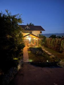 a house with a lit up porch with a patio at Villa La Vida in Sarajevo