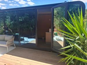 a glass extension of a house with a garden at FALCOARIA Eco in Setúbal