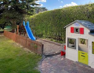 a play house and a slide in a yard at SKiPER Dębki in Dębki