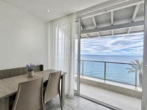 a dining room with a view of the ocean at Myrto Rooms in Pefkochori