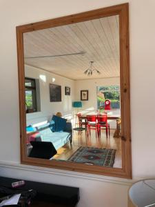 a mirror reflecting a living room with a couch and a table at Ashgrove, Kinsale in Kinsale +36 photos