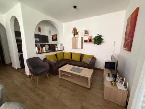 a living room with a couch and a table at Mária Villa in Balatonmáriafürdő