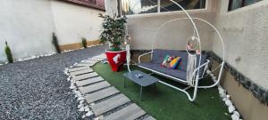 a porch with a chair and a potted plant at Vila Zeus in Cristian