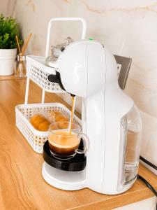 a coffee maker on a counter with a cup of coffee at Palazzo Solera Rooms in Casarano +8 photos