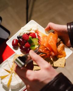 a person taking a picture of a plate of food at Beausejour Ranelagh in Paris