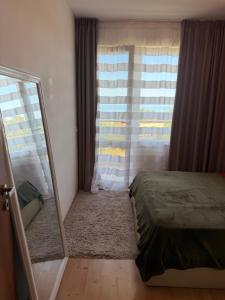 a bedroom with a mirror and a bed and a window at SOLITA Apartment with Panoramic View in Byala