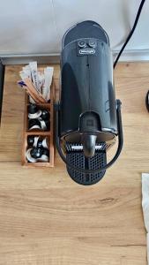 a coffee maker sitting on top of a table at Caro Central Apartament 3 Camere in Râmnicu Vâlcea