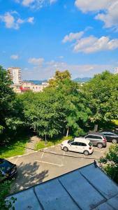 a parking lot with cars parked in a parking lot at Caro Central Apartament 3 Camere in Râmnicu Vâlcea