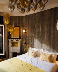 a bedroom with a bed with balloons above it at Beausejour Ranelagh in Paris