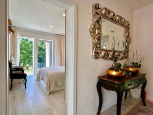 a bedroom with a mirror and a table with a bed at ORNI House in Hazlov +48 photos