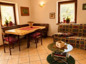 a living room with a table and a couch at Casa Cappuccetto in Imer