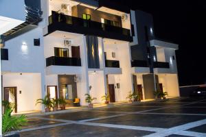 a building with a parking lot in front of it at Dream Nest in Benin City