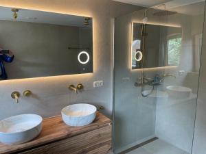 a bathroom with two sinks and a mirror at De Vechthoeve in Dalfsen