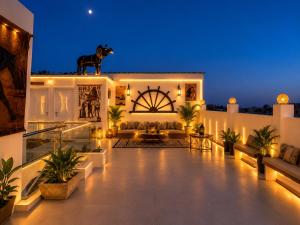 a house with a horse on the roof at night at Pyramids Gardens Hotel in Cairo