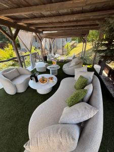 a group of couches and tables in a living room at Plitvice Lakes Hotel Ethno Houses in Plitvička Jezera