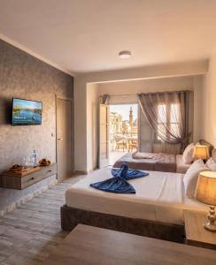 a large bedroom with two beds and a balcony at Parque Praca hotel in Cairo