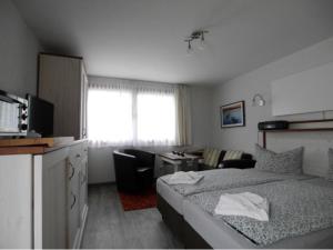 a hotel room with a bed and a living room at Bungalow in Bansin