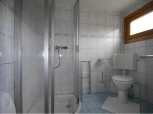 a bathroom with a shower and a toilet and a sink at Bungalow in Bansin