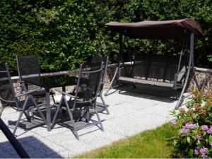 a table and chairs and an umbrella on a patio at Bungalow in Bansin