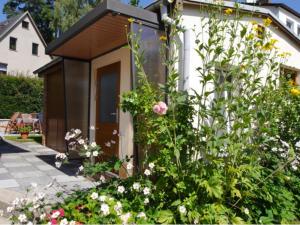 a flower garden in front of a small shed at Bungalow in Bansin