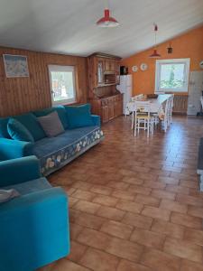 a living room with a blue couch and a kitchen at Appartamenti Bice Abetone in Abetone