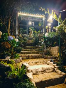 a garden at night with a sign that reads vancouver gardens at VANY Glamping in Pasuruan