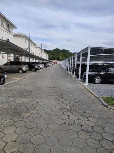 a row of cars parked in a parking lot at Apt confortável in Camboriú +5 photos