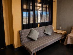 a couch sitting in a room with a window at Tierras Mágicas in Villa Pehuenia