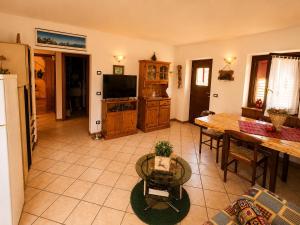 a living room with a table and a dining room at Casa Cappuccetto in Imer