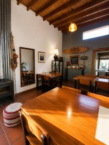 a dining room with a large wooden table and chairs at Posada Tordillo Hosteria Rural in Chascomús