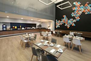 a restaurant with tables and chairs and balloons on the wall at City Express Plus by Marriott Monterrey Nuevo Sur in Monterrey