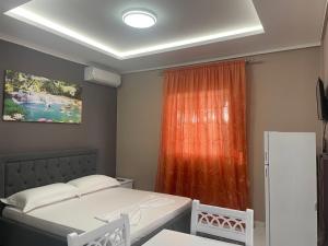 a room with two beds and a window at Vila Topi in Vlorë