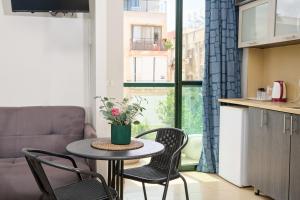 a small table and chairs in a kitchen with a window at H7 TLV in Tel Aviv