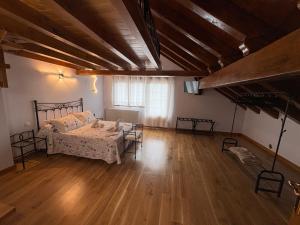 a bedroom with a bed and a wooden floor at La Casona El Carrascal in La Gandara +18 photos