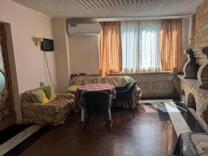 a bedroom with a bed and a couch and a chair at Guest House Lilia in Yerevan