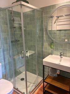 a bathroom with a shower and a sink at Hotel Le Moulin du Château in Saint-Laurent-du-Verdon +46 photos