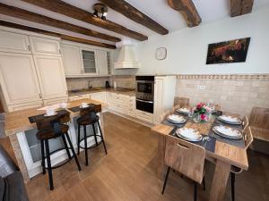 a kitchen with a table and chairs in it at La Casona El Carrascal in La Gandara
