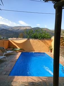 a swimming pool with a view of the mountains at Casas Amaro in Órgiva
