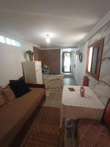 a living room with a couch and a table at Maison Kram Plage in Le Kram
